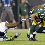 Green Bay Packers' Aaron Rodgers (12) is stopped short of a first down by Seattle Seahawks' Bobby Wagner 54 during the first half of an NFL football game Sunday, Sept. 20, 2015, in Green Bay, Wis. (AP Photo/Jeffrey Phelps)