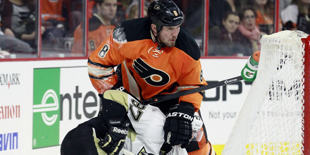 Philadelphia Flyers defenseman Nicklas Grossmann holds Pittsburgh Penguins' Sidney Crosby down on t...