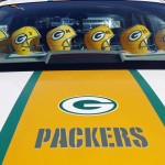 Green Bay Packers helmets line the back of a car before an NFL football game between the Green Bay Packers and the Seattle Seahawks Sunday, Sept. 20, 2015, in Green Bay, Wis. (AP Photo/Mike Roemer)