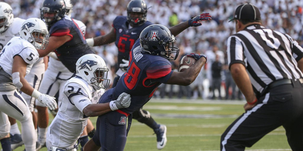 Arizona’s Nick Wilson (28) scores against Nevada’s Kendall Johnson (26) during the firs...