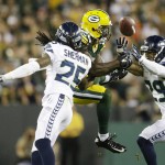 Seattle Seahawks' Richard Sherman (25) is called for pass interference on this pass to Green Bay Packers' James Jones during the first half of an NFL football game Sunday, Sept. 20, 2015, in Green Bay, Wis. Also pictured is Earl Thomas (29). (AP Photo/Jeffrey Phelps)
