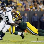 Green Bay Packers' Mike Daniels tries to stop Seattle Seahawks' Russell Wilson (3) during the first half of an NFL football game Sunday, Sept. 20, 2015, in Green Bay, Wis. (AP Photo/Mike Roemer)