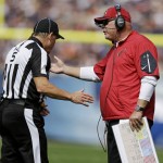 Arizona Cardinals head coach Bruce Arians argues a call with head linesman John McGrath (5) during the first half of an NFL football game, Sunday, Sept. 20, 2015, in Chicago. (AP Photo/Michael Conroy)