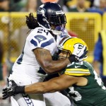 Green Bay Packers' Nick Perry stops Seattle Seahawks' Marshawn Lynch on a run during the first half of an NFL football game Sunday, Sept. 20, 2015, in Green Bay, Wis. (AP Photo/Mike Roemer)