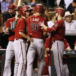 Arizona Diamondbacks' Jake Lamb is congratulated by teammates after scoring a run against the Colorado Rockies during the sixth inning of a baseball game Wednesday, Sept. 2, 2015, in Denver. (AP Photo/Jack Dempsey)