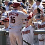 Arizona Diamondbacks' Phil Gosselin (15) is high-fived at the dugout after scoring on a single by Chris Owings during the second inning of a baseball game against the San Francisco Giants, Saturday, Sept. 19, 2015, in San Francisco. (AP Photo/Marcio Jose Sanchez)