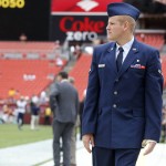 U.S. Air Force Airman 1st Class Spencer Stone, who was injured while helping stop an attack on a Paris-bound train, walks along the sidelines before an NFL football game between the Washington Redskins and the St. Louis Rams in Landover, Md., Sunday, Sept. 20, 2015. (AP Photo/Patrick Semansky)