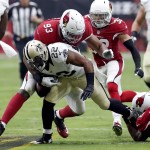 New Orleans Saints running back Mark Ingram (22) is hit by Arizona Cardinals defensive end Calais Campbell (93) during the first half of an NFL football game, Sunday, Sept. 13, 2015, in Glendale, Ariz. (AP Photo/Rick Scuteri)