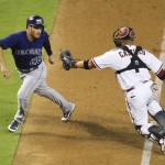 Colorado Rockies's Nolan Arenado avoids the tag by Arizona Diamondbacks catcher Welington Andres Castillo during the eighth inning of a baseball game Tuesday, Sept. 29, 2015, in Phoenix. (Michael Chow/The Arizona Republic via AP)  MARICOPA COUNTY OUT; MAGS OUT; NO SALES; MANDATORY CREDIT