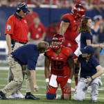 Arizona quarterback Anu Solomon (12) is checked by trainers during the first half of an NCAA college football game against UCLA, Saturday, Sept. 26, 2015, in Tucson, Ariz. (AP Photo/Rick Scuteri)