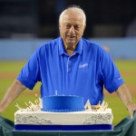Former Los Angeles Dodgers manager Tommy Lasorda poses with his birthday cake as he celebrates his 88th birthday prior to a baseball game against the Arizona Diamondbacks, Tuesday, Sept. 22, 2015, in Los Angeles. (AP Photo/Mark J. Terrill)