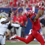 Arizona wide receiver Nate Phillips, right, catches a touchdown pass in front of UCLA defensive back Ishmael Adams during the first half of an NCAA college football game, Saturday, Sept. 26, 2015, in Tucson, Ariz. (AP Photo/Rick Scuteri)