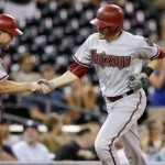 Arizona Diamondbacks' A.J. Pollock, right, is greeted by third base coach Andy Green after hitting a grand slam against the San Diego Padres during the second inning of a baseball game Friday, Sept. 25, 2015, in San Diego. (AP Photo/Gregory Bull)