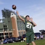 Max Martin throws a football outside Lambeau Field before an NFL football game between the Green Bay Packers and the Seattle Seahawks Sunday, Sept. 20, 2015, in Green Bay, Wis. (AP Photo/Jeffrey Phelps)