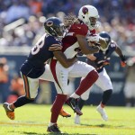 Arizona Cardinals wide receiver Larry Fitzgerald (11) is tackled from behind by Chicago Bears cornerback Kyle Fuller (23) during the second half of an NFL football game, Sunday, Sept. 20, 2015, in Chicago. (AP Photo/Michael Conroy)
