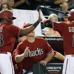 Arizona Diamondbacks' Socrates Brito (68) gives a high-five to Phil Gosselin (15) after Brito scored on a sacrifice fly by Gosselin during the fifth inning of a baseball game against the Colorado Rockies Wednesday, Sept. 30, 2015, in Phoenix. (AP Photo/Ross D. Franklin)