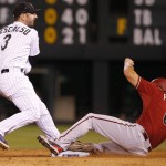 Colorado Rockies shortstop Daniel Descalso forces out Arizona Diamondbacks' David Peralta at second during the sixth inning of the second game of a baseball doubleheader Tuesday, Sept. 1, 2015, in Denver. (AP Photo/Jack Dempsey)