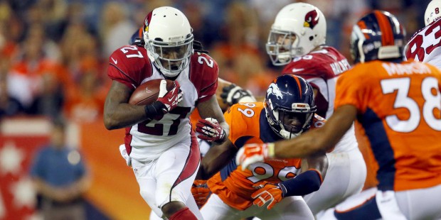Arizona Cardinals running back Chris Johnson (27) escapes the reach of Denver Broncos linebacker Ge...