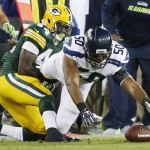 Seattle Seahawks' K.J. Wright recovers a fumble of Green Bay Packers' James Starks (44) during the first half of an NFL football game Sunday, Sept. 20, 2015, in Green Bay, Wis. (AP Photo/Mike Roemer)