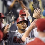 Arizona Diamondbacks' Yasmany Tomas is congratulated after hitting a solo home run during the fourth inning of a baseball game against the Los Angeles Dodgers, Monday, Sept. 21, 2015, in Los Angeles. (AP Photo/Mark J. Terrill)