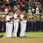 Arizona Diamondbacks players line up for a moment of silence before a baseball game against the Los Angeles Dodgers, Friday, Sept. 11, 2015, in Phoenix. (AP Photo/Rick Scuteri)