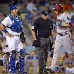 Arizona Diamondbacks' A.J. Pollock, right, crosses home after hitting a solo home run as Los Angeles Dodgers catcher A.J. Ellis, left, watches along with home plate umpire Hunter Wendelstedt during the seventh inning of a baseball game, Tuesday, Sept. 22, 2015, in Los Angeles. (AP Photo/Mark J. Terrill)