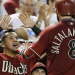 Arizona Diamondbacks' Jarrod Saltalamacchia (8) celebrates his home run against the San Diego Padres with David Peralta, left, during the sixth inning of a baseball game Wednesday, Sept. 16, 2015, in Phoenix. (AP Photo/Ross D. Franklin)
