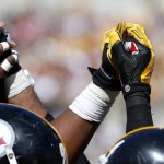 Members of the Pittsburgh Steelers defense raise their hands as they hold them in the huddle in the fourth quarter of an NFL football game against the San Francisco 49ers, Sunday, Sept. 20, 2015, in Pittsburgh. The Steelers won 43-18. (AP Photo/Gene J. Puskar)