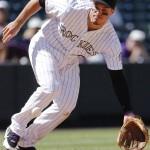 Colorado Rockies third baseman Nolan Arenado scoops up a ground ball hit by Arizona Diamondbacks' Brandon Drury during the fourth inning of the first game of a baseball double header Tuesday, Sept. 1, 2015, in Denver. (AP Photo/Jack Dempsey)
