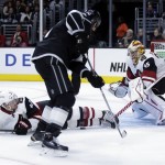 Arizona Coyotes' Alex Grant, left, and goalie Louis Domingue, right, block a shot by Los Angeles Kings left wing Milan Lucic during the second period of an NHL preseason hockey game in Los Angeles, Tuesday, Sept. 22, 2015. (AP Photo/Chris Carlson)