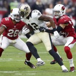 New Orleans Saints wide receiver Marques Colston (12) is hit by Arizona Cardinals free safety Tyrann Mathieu (32) and Rashad Johnson (26) during the first half of an NFL football game, Sunday, Sept. 13, 2015, in Glendale, Ariz. (AP Photo/Rick Scuteri)
