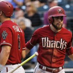 Arizona Diamondbacks' Ender Inciarte is greeted at home plate by David Peralta, left, after scoring on an A.J. Pollock sacrifice fly against the Colorado Rockies during the first inning of a baseball game Wednesday, Sept. 2, 2015, in Denver. (AP Photo/Jack Dempsey)