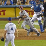 Arizona Diamondbacks' Paul Goldschmidt, center, hits a solo home run as Los Angeles Dodgers relief pitcher Chris Hatcher, left, and catcher A.J. Ellis watch during the seventh inning of a baseball game, Tuesday, Sept. 22, 2015, in Los Angeles. (AP Photo/Mark J. Terrill)