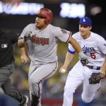 Los Angeles Dodgers shortstop Corey Seager, right, gets set to tag out Arizona Diamondbacks' Yasmany Tomas after Tomas got caught between first and second as he tried to stretch a single to a double during the second inning of a baseball game, Tuesday, Sept. 22, 2015, in Los Angeles. (AP Photo/Mark J. Terrill)