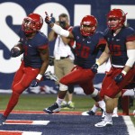 Arizona safety Jamar Allah (7) celebrates with Anthony Lopez (28) and Haden Gregory after scoring a touchdown during the second half of an NCAA college football game against UTSA, Thursday, Sept. 3, 2015, in Tucson, Ariz. (AP Photo/Rick Scuteri)