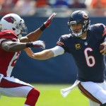 Chicago Bears quarterback Jay Cutler stiff arms Arizona Cardinals strong safety Deone Bucannon during the second quarter of an NFL football game, Sunday, Sept. 20, 2015 in Chicago. (Steve Lundy/Daily Herald via AP) MANDATORY CREDIT; MAGS OUT