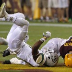 Cal Poly's Chris Fletcher, left, takes down Arizona State's Mike Bercovici, right, during the first half of an NCAA college football game Saturday, Sept. 12, 2015, in Tempe, Ariz. (AP Photo/Ross D. Franklin)