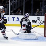 Arizona Coyotes left wing Jordan Martinook, left, scores past Los Angeles Kings goalie Peter Budaj during the third period of an NHL preseason hockey game in Los Angeles, Tuesday, Sept. 22, 2015. (AP Photo/Chris Carlson)
