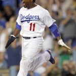 Los Angeles Dodgers' Jimmy Rollins reacts as he scores on a double by Chase Utley, against the Arizona Diamondbacks during the eighth inning of a baseball game in Los Angeles, Wednesday, Sept. 23, 2015. (AP Photo/Alex Gallardo)
