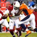 Arizona Cardinals quarterback Phillip Sims (1) is sacked by Denver Broncos linebacker Shaquil Barrett (48) during the first half of an NFL preseason football game, Thursday, Sept. 3, 2015, in Denver. (AP Photo/Jack Dempsey)