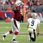 Arizona Cardinals defensive end Frostee Rucker (92) celebrates a stop as New Orleans Saints quarterback Drew Brees (9) gets up during the second half of an NFL football game, Sunday, Sept. 13, 2015, in Glendale, Ariz. (AP Photo/Rick Scuteri)