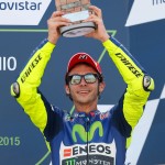 Moto GP rider Valentino Rossi of Italy holds his trophy after finishing third in the Aragon Motorcycle Grand Prix at the Aragon Motorland racetrack in Alcaniz, Spain, Sunday, Sept. 27, 2015. (AP Photo/Francisco Seco)