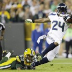 Seattle Seahawks' Marshawn Lynch is tripped up by Green Bay Packers' Nick Perry (53) during the first half of an NFL football game Sunday, Sept. 20, 2015, in Green Bay, Wis. (AP Photo/Jeffrey Phelps)
