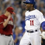 Los Angeles Dodgers' Jimmy Rollins (11) scores on a double by Chase Utley, as Arizona Diamondbacks relief pitcher David Hernandez heads back to the mound during the eighth inning of a baseball game in Los Angeles, Wednesday, Sept. 23, 2015. (AP Photo/Alex Gallardo)