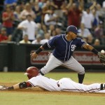 Arizona Diamondbacks' Nick Ahmed, bottom, slides into third base safely in front of San Diego Padres third baseman Yangervis Solarte after hitting an RBI triple in the seventh inning during a baseball game, Tuesday, Sept. 15, 2015, in Phoenix. (AP Photo/Rick Scuteri)