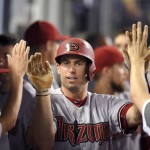 Arizona Diamondbacks' Paul Goldschmidt, right, is congratulated by teammates after hitting a solo home run during the seventh inning of a baseball game against the Los Angeles Dodgers, Tuesday, Sept. 22, 2015, in Los Angeles. (AP Photo/Mark J. Terrill)