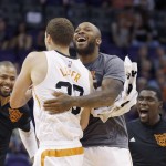Phoenix Suns' Jon Leuer, second from left, celebrates his dunk against the Sacramento Kings with teammates Tyson Chandler, left, Kyle Casey, right, and P.J. Tucker during the first half of an NBA preseason basketball game Wednesday, Oct. 7, 2015, in Phoenix. (AP Photo/Ross D. Franklin)