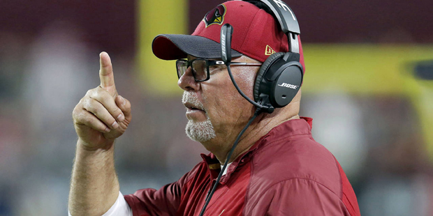 Arizona Cardinals head coach Bruce Arians makes a call during the first half of an NFL football gam...