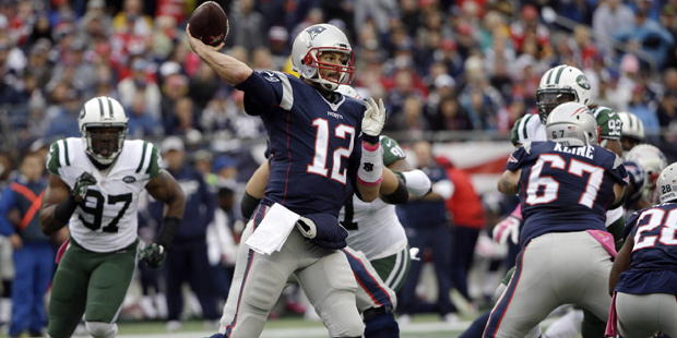 New England Patriots quarterback Tom Brady (12) passes against the New York Jets during the first h...