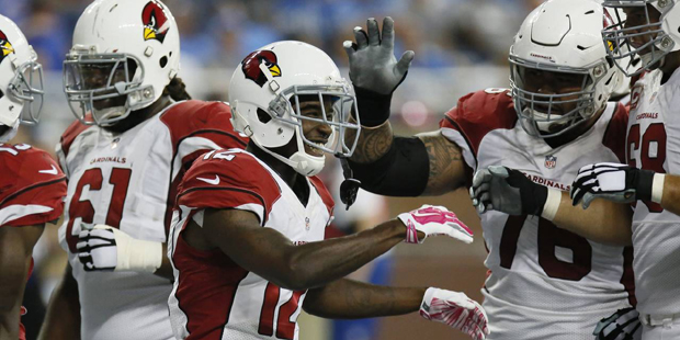 Arizona Cardinals wide receiver John Brown (12) is congratulated by teammates after his 18-yard rec...